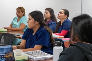 Students at tables at the Workforce Development Hub